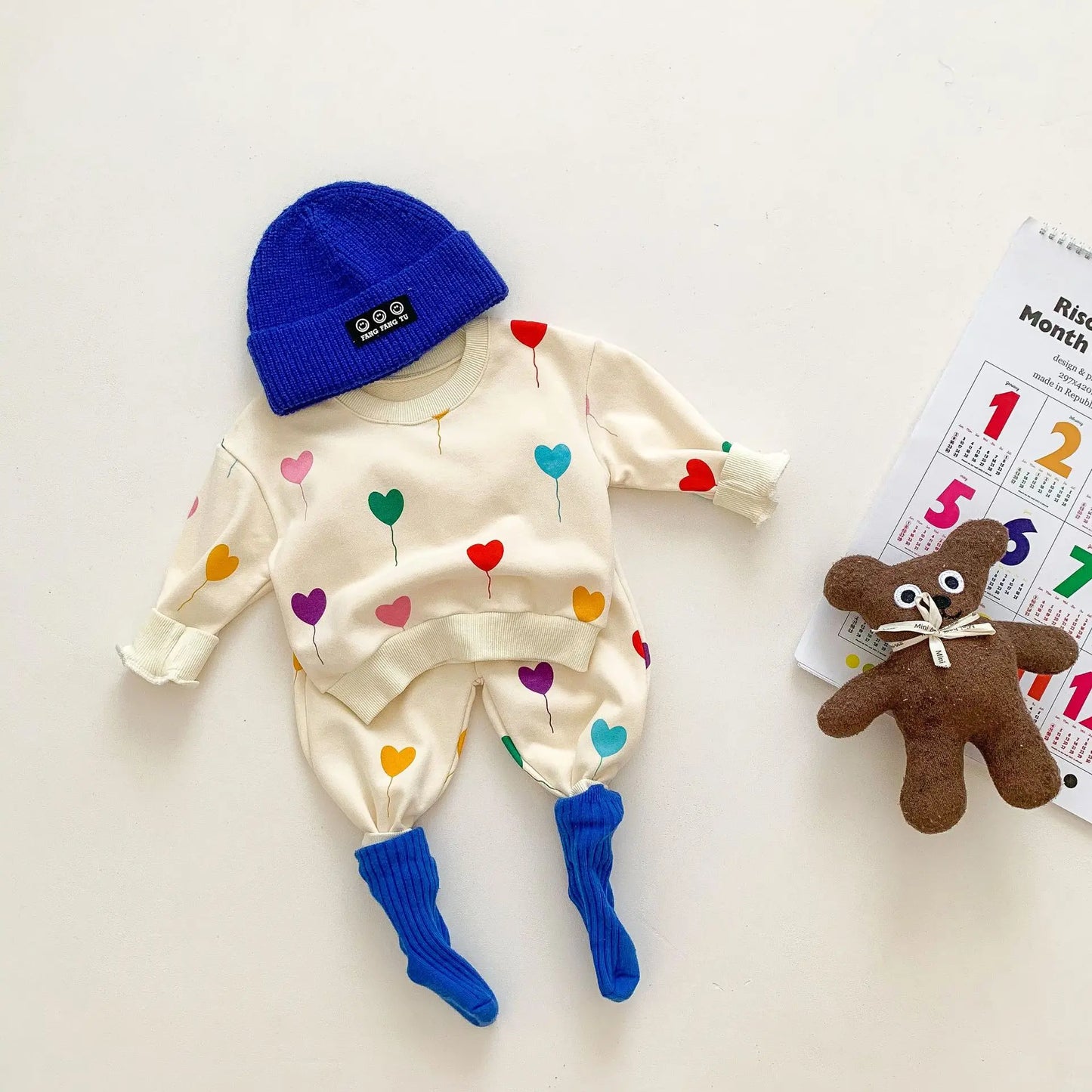 Comfortable cotton spring tracksuit for baby, featuring an all-over heart print design.