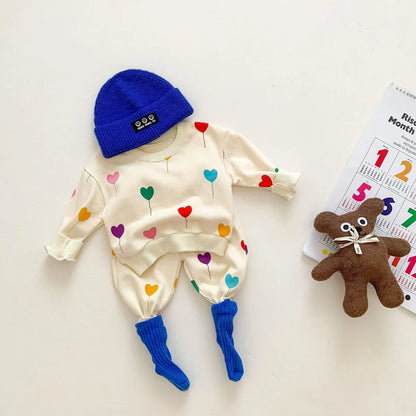 Comfortable cotton spring tracksuit for baby, featuring an all-over heart print design.