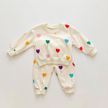 Complete baby tracksuit with heart pattern, super soft cotton for ultimate comfort and style.