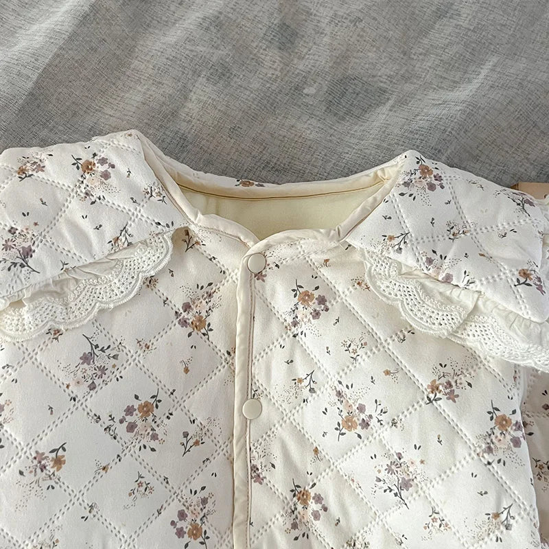 Cozy baby floral winter romper, fur-lined fabric, and a stylish coordinating baby hat.