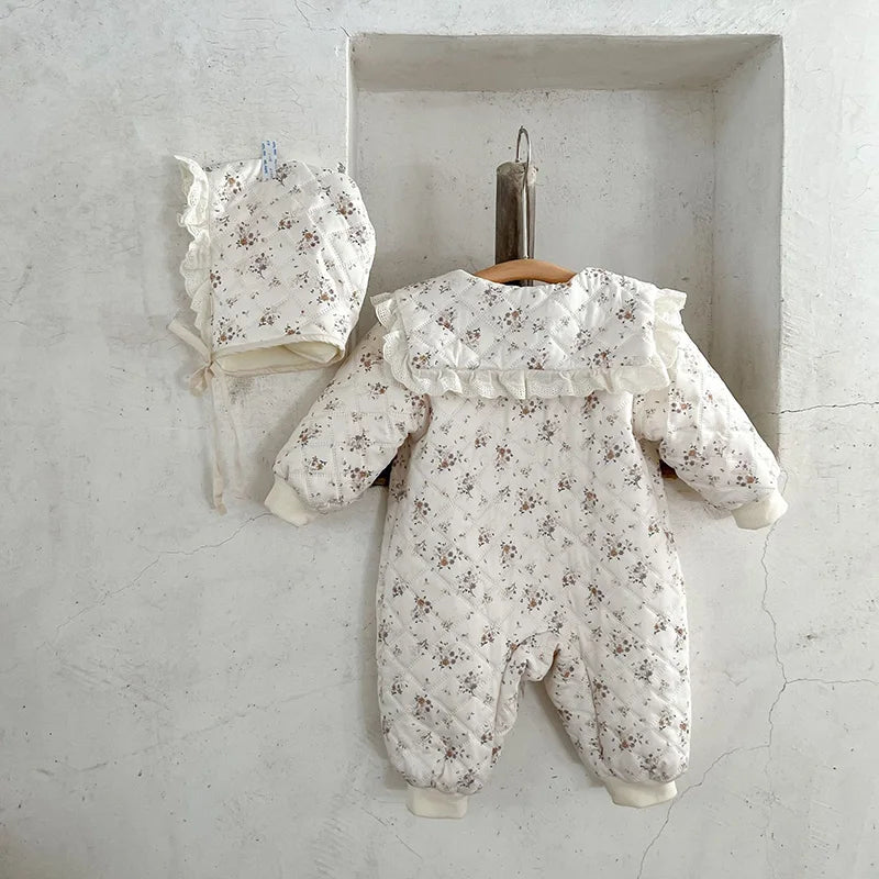 Warm unisex baby winter outfit: floral romper with fur lining and cute baby hat.