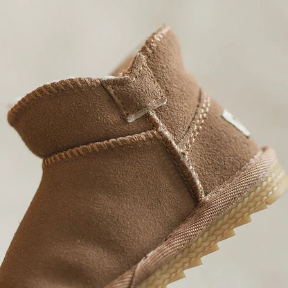 Back view of brown baby snow boots, showing reinforced heel and non-slip tread for infant safety