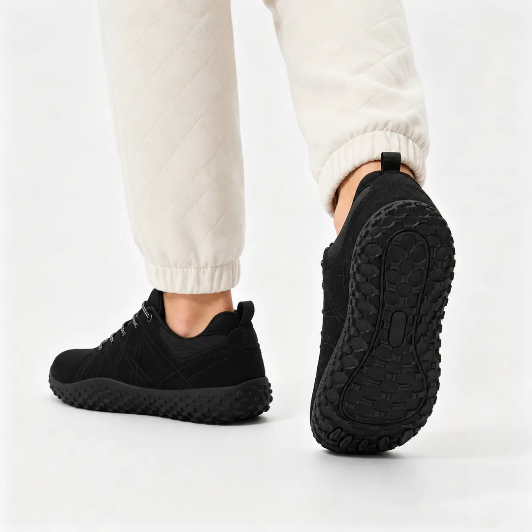 Minimalist trail trainers with a flexible zero-drop design for enhanced outdoor comfort.