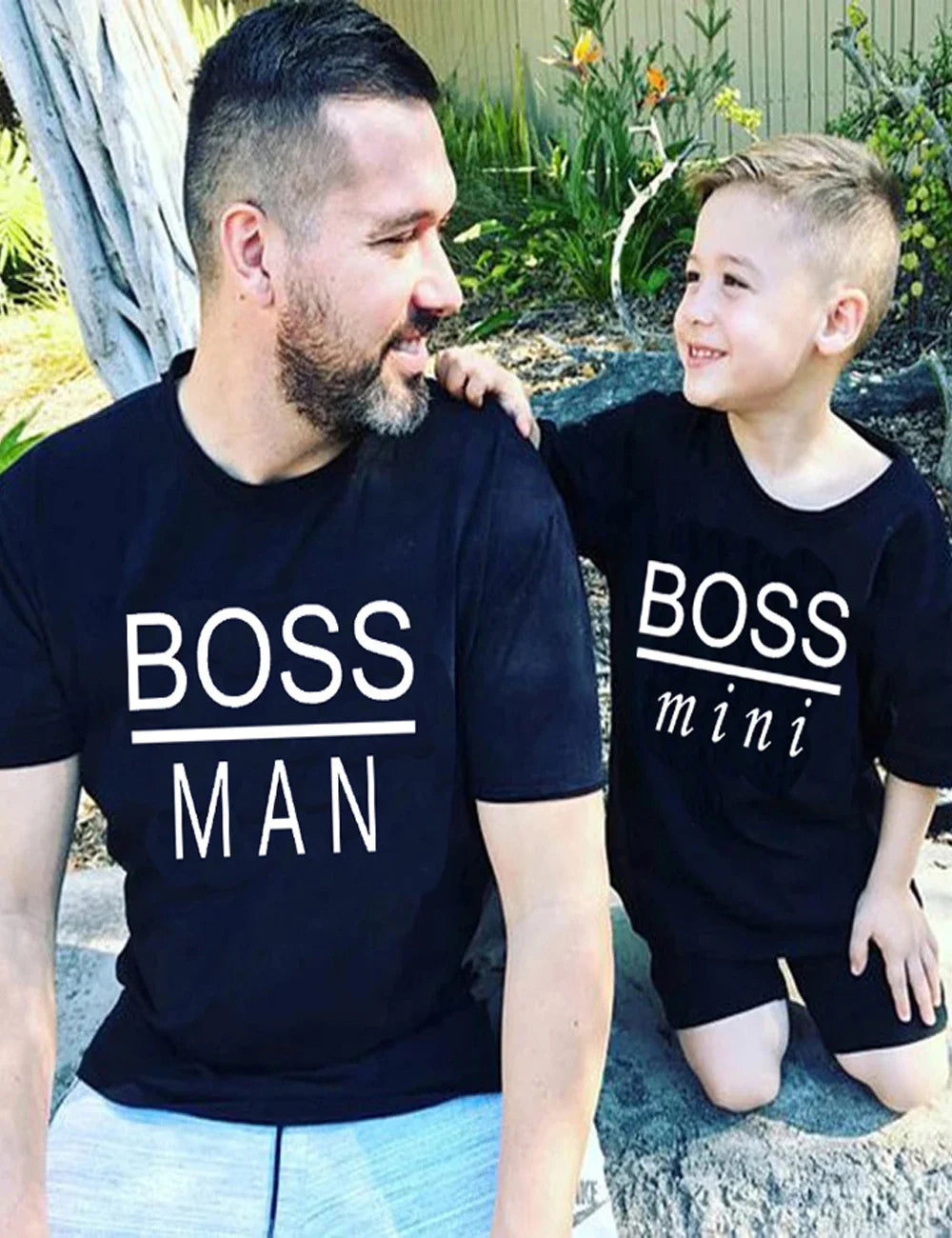 Model wearing the 'Boss Man' T-shirt, paired with jeans, demonstrating a casual unisex look