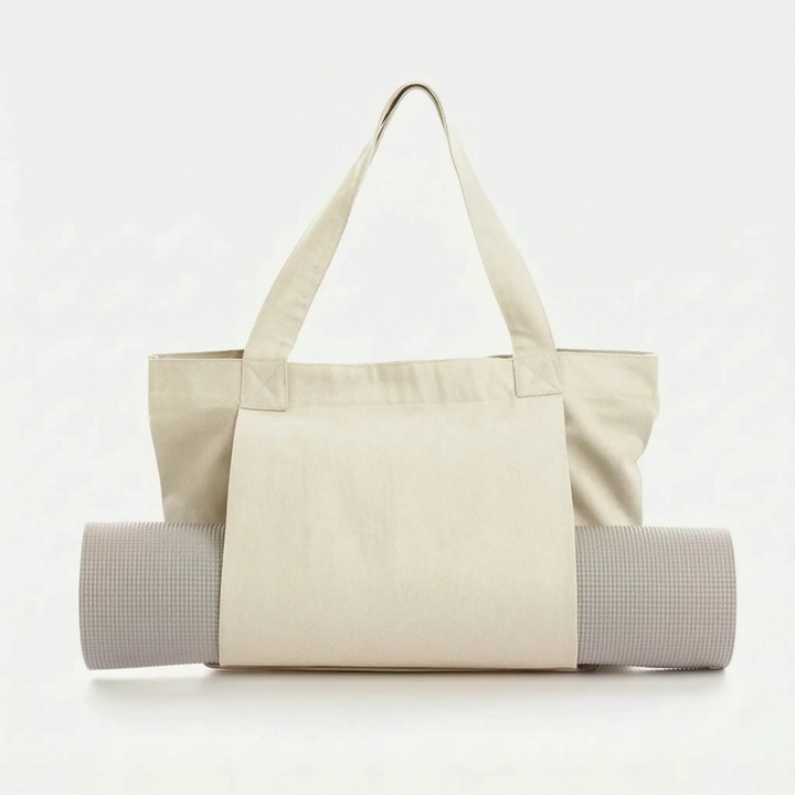 Person carrying a versatile yoga mat tote bag over shoulder, hands-free, heading to a yoga class.
