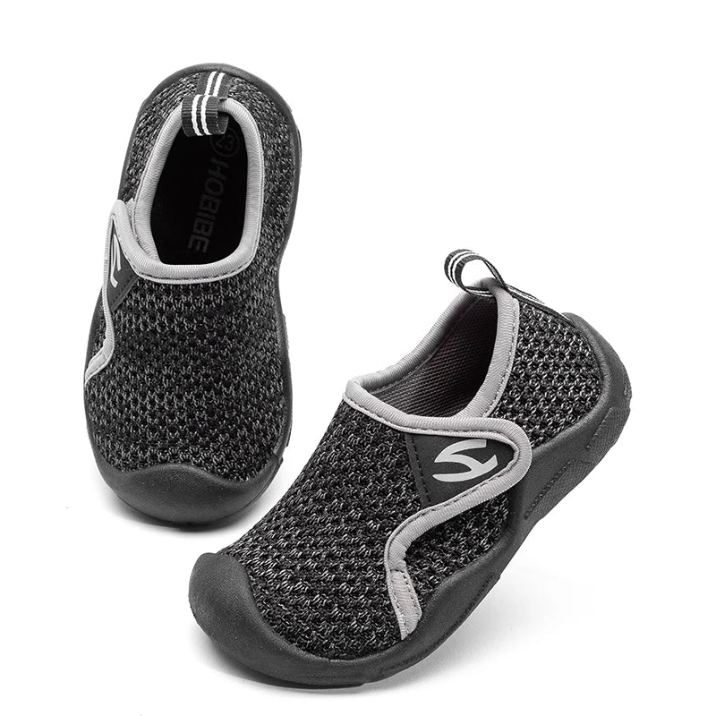 Toddler wearing red unisex breathable shoes with flexible soles, playing outdoors.