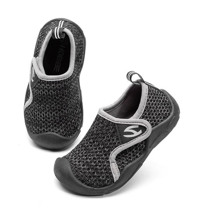 Toddler wearing red unisex breathable shoes with flexible soles, playing outdoors.