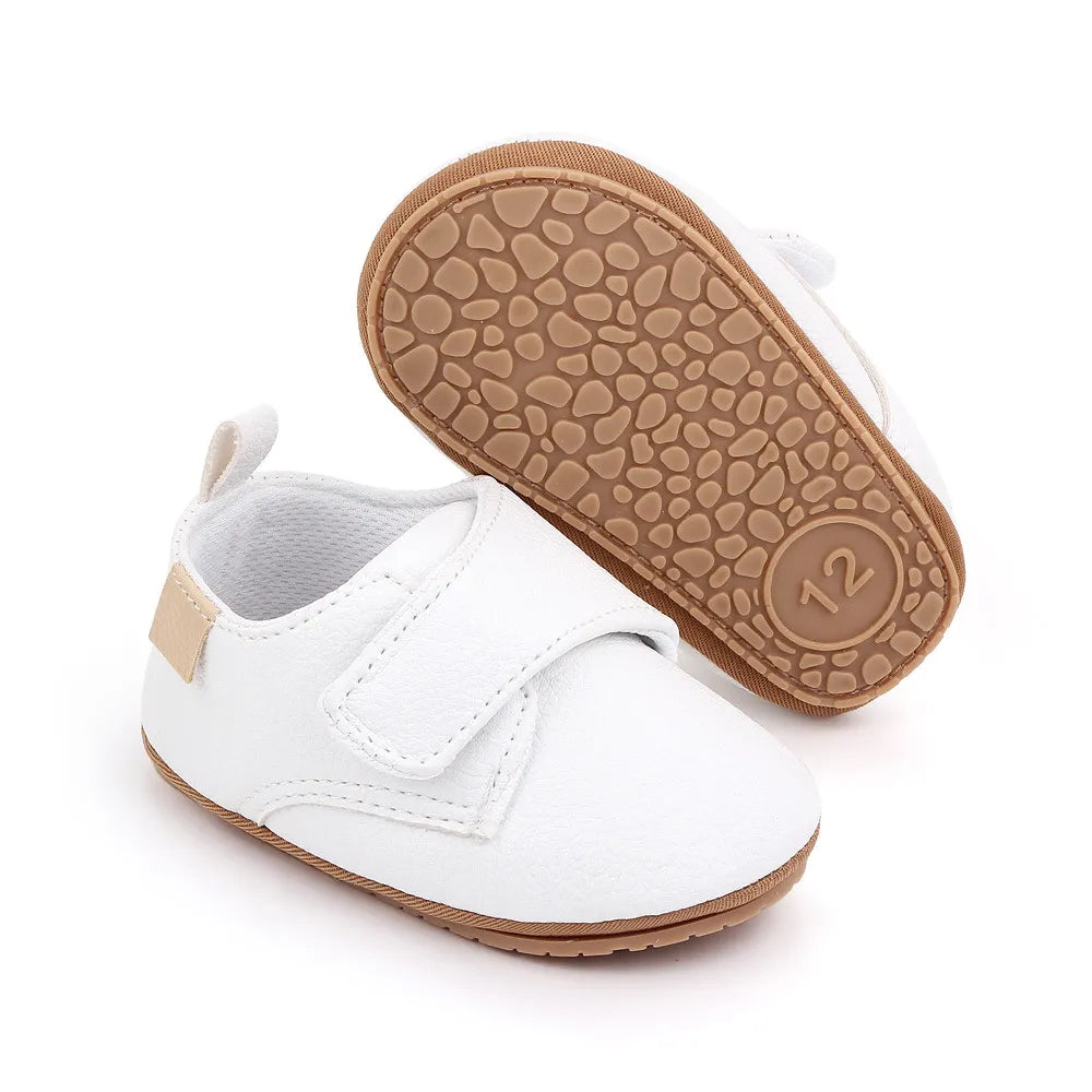 Close-up of hook and loop strap on classic leather baby anti-slip first walker shoe