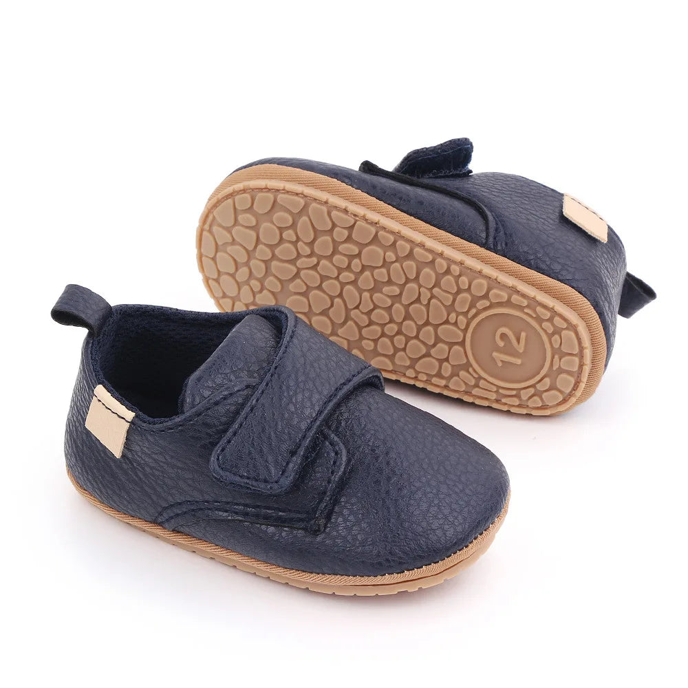 Pair of classic white leather baby anti-slip first walker shoes with packaging