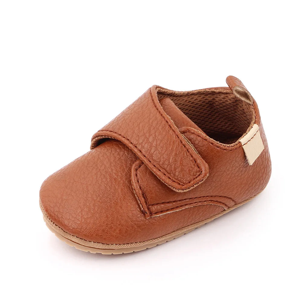 Classic grey leather baby anti-slip first walker shoes, side view, durable and flexible