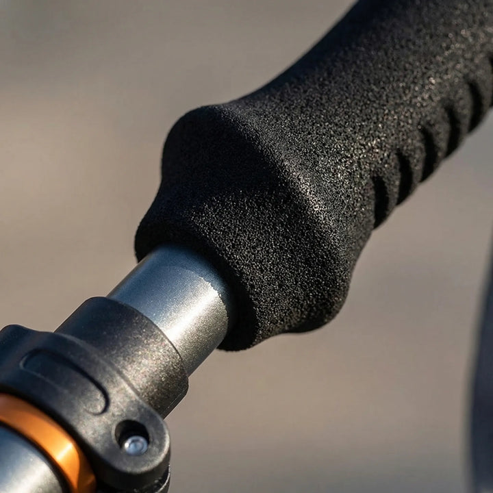 Adjustable unisex hiking pole, extended for trail support, lightweight collapsible design for adventurers.