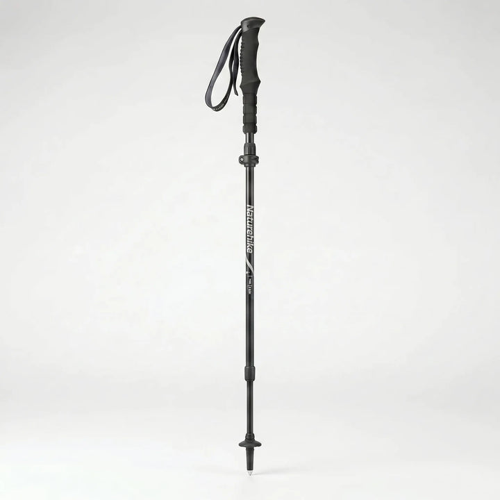 Ergonomic handle & quick-lock mechanism of a compact folding trekking pole, durable outdoor hiking gear.
