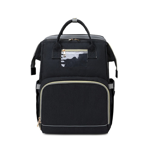 Multifunctional diaper bag with portable changing station. Includes a travel crib for convenience.