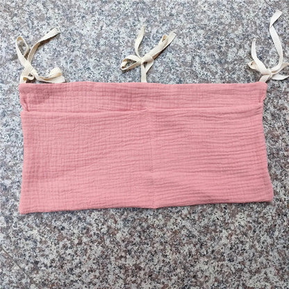 Hanging crib caddy with multiple pockets for baby essentials & accessories