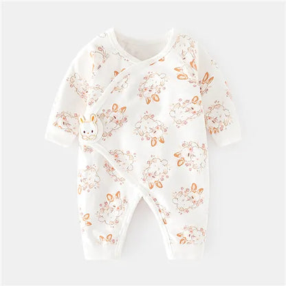 Baby in unisex cotton romper, playing on a blanket, showing full range of motion, comfort