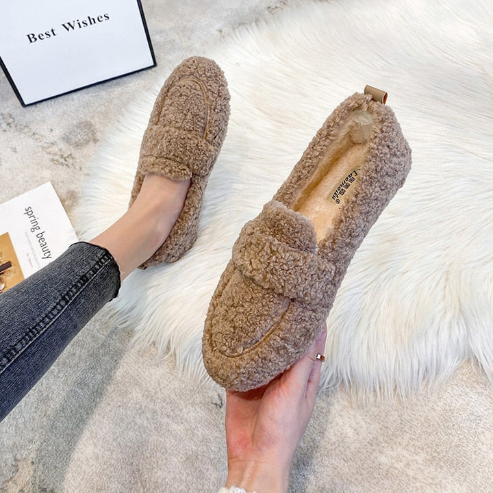 Black plush unisex winter slippers, ideal cozy indoor house shoes for warm comfort.