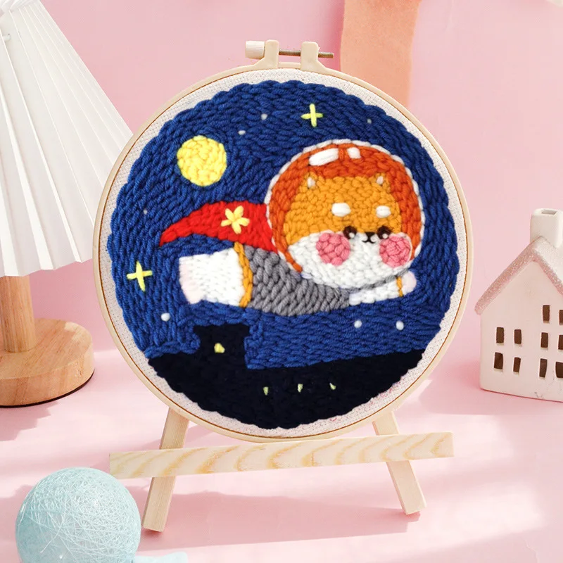 Creative punch needle kit box showing contents: needle, hoop, fabric, and yarn for DIY decor