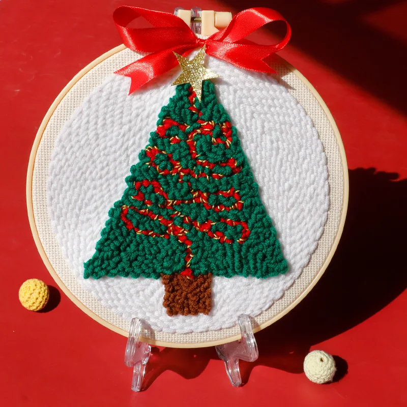 A person proudly displaying their finished punch needle art piece made with the DIY kit