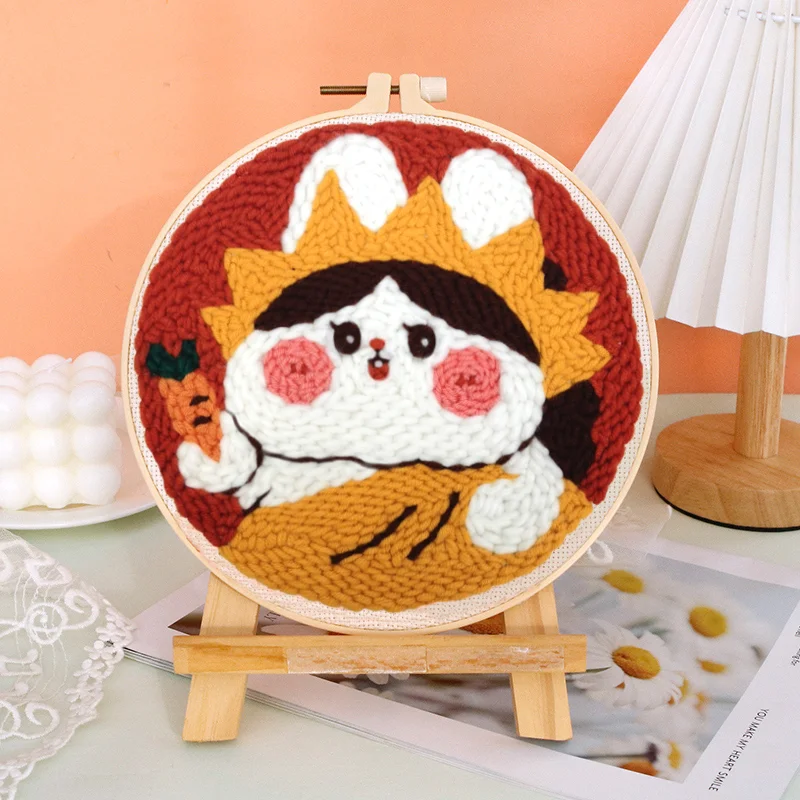 A person's hands engaged in punch needle art using the creative kit, creating a home decor item