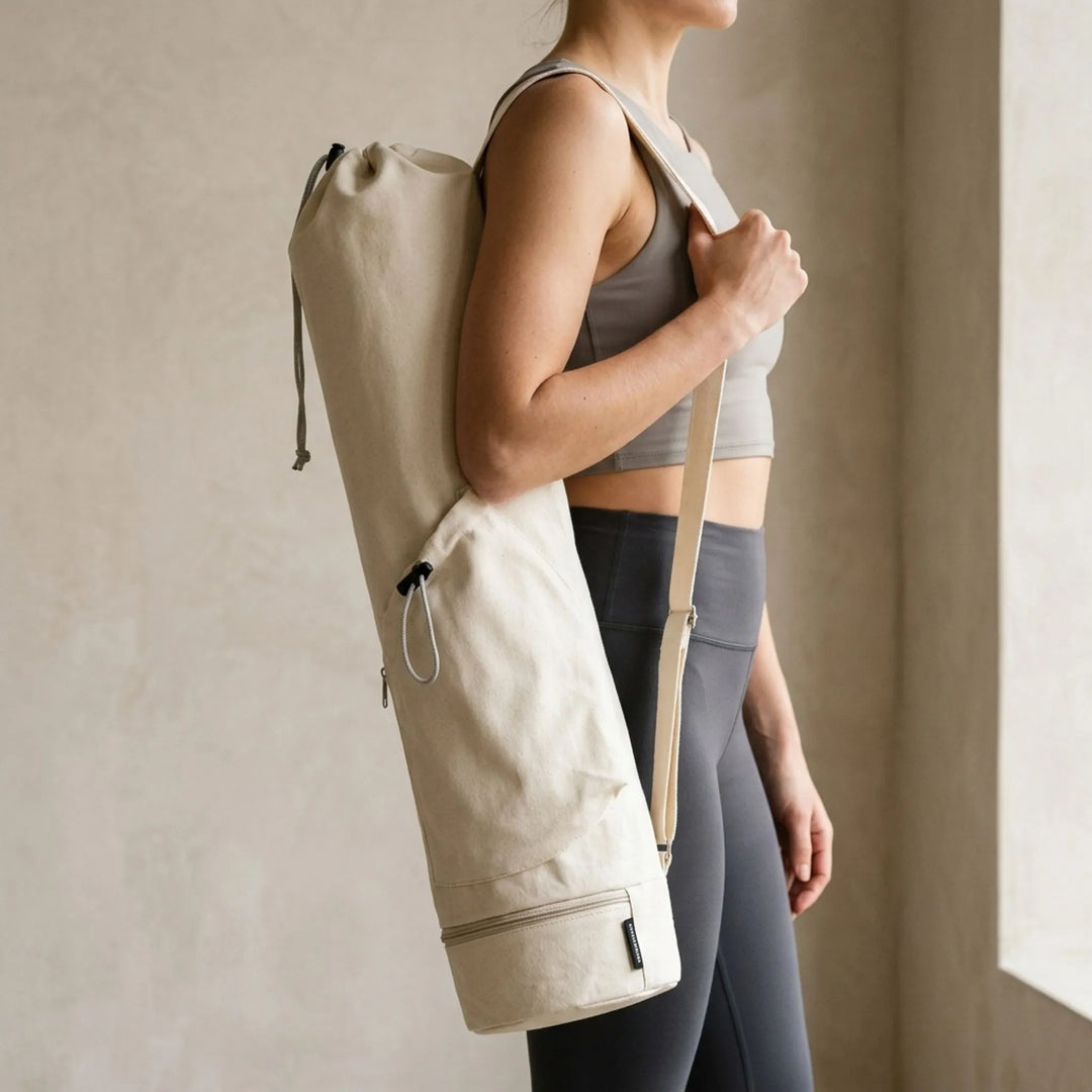 Unisex cylindrical yoga mat carrier bag in green, ideal for gym, studio, or fitness class.