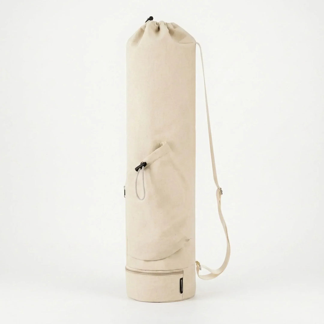 Pink cylindrical yoga mat bag with adjustable strap for hands-free transport of your mat.