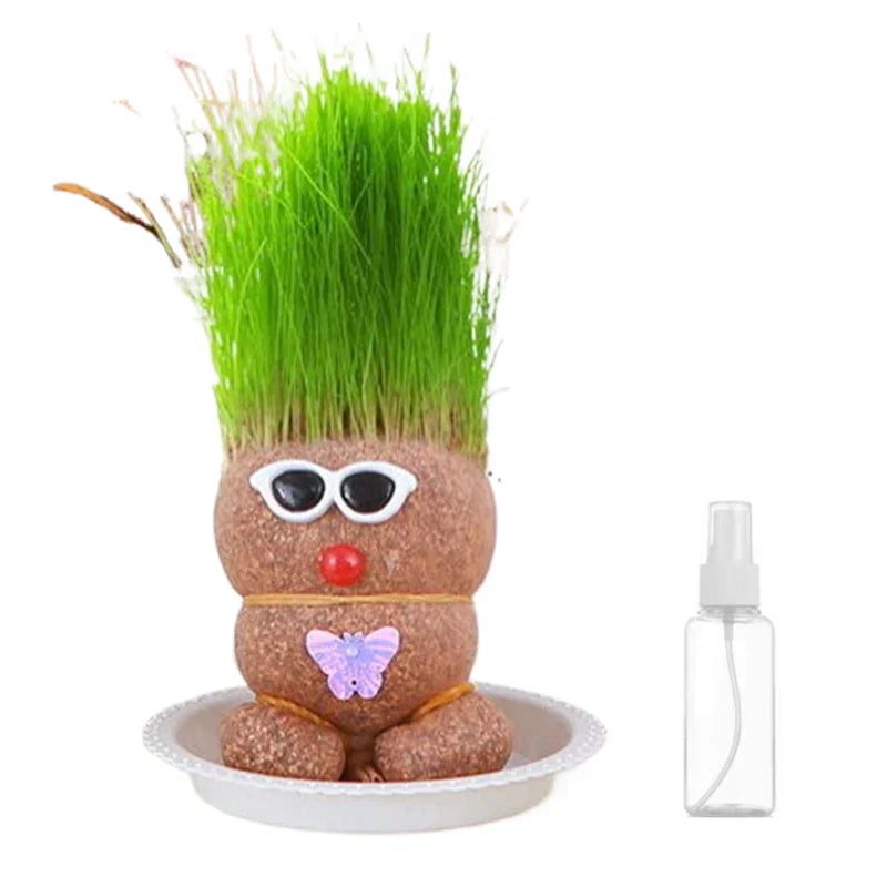 A creatively styled Grass Head kit with accessories, showcasing its potential as a fun houseplant