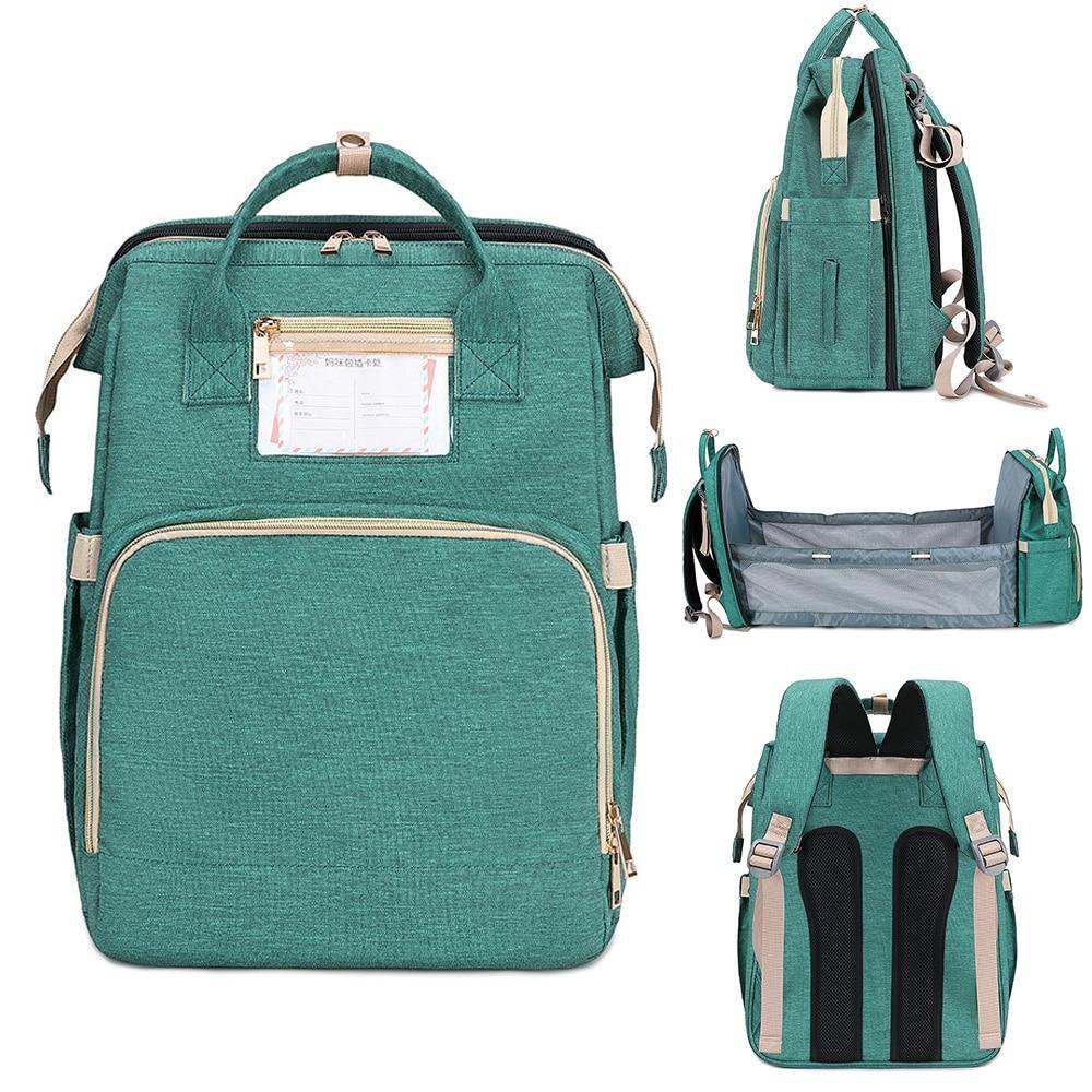 Unisex diaper bag backpack with a foldable baby bed for travel. Waterproof design.