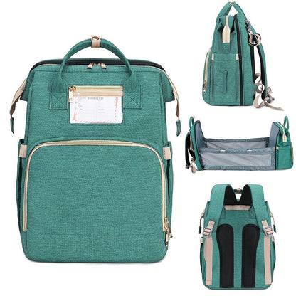 Unisex diaper bag backpack with a foldable baby bed for travel. Waterproof design.