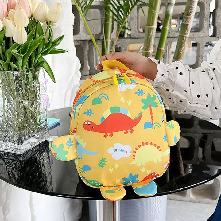 Front view of a green dinosaur-themed preschool backpack, cute kids school bag for baby & toddlers