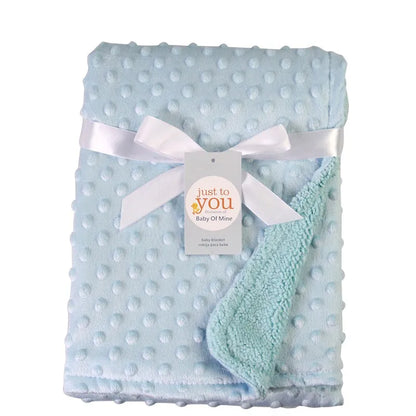 Newborn swaddled in a soft unisex double layer cotton baby blanket, ensuring warmth and comfort.