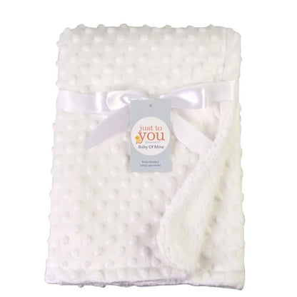 Unisex baby blanket in a neutral color, double layer cotton for ultimate softness and nursery essential.