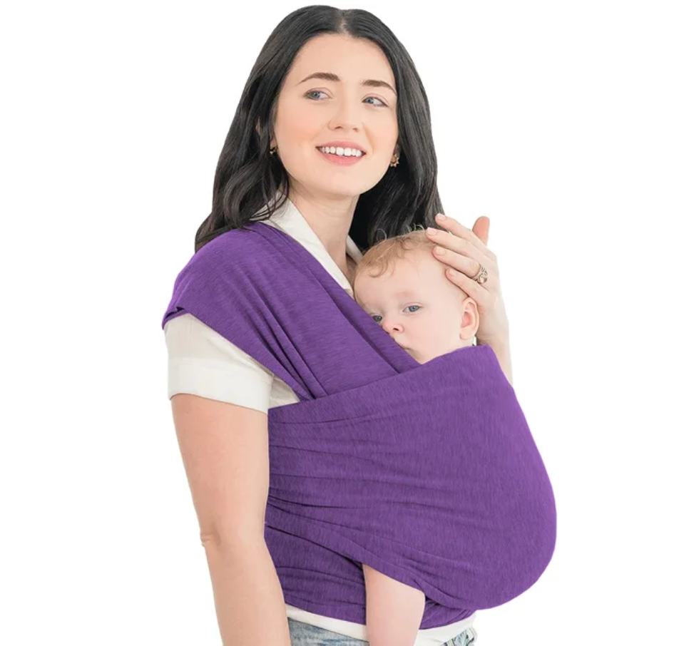 Parents carrying baby hands-free in an ergonomic, breathable baby wrap carrier, outdoor shot
