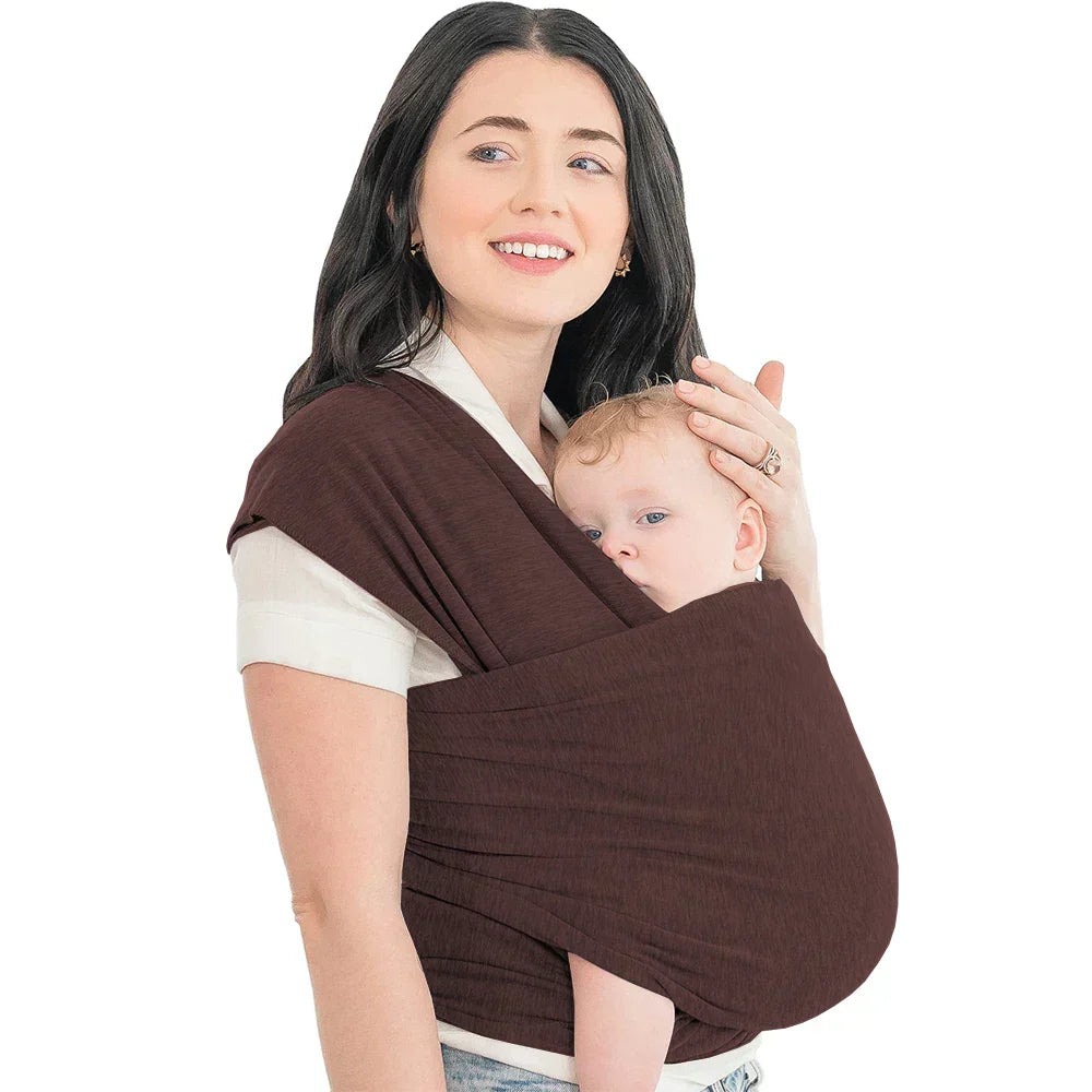 Close-up of a baby snug in an ergonomic baby carrier wrap, showing breathable fabric detail