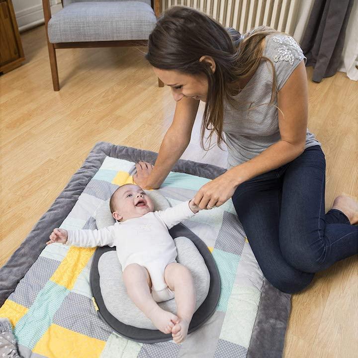 Adjustable baby sleep positioner with soft fabric, essential for newborn comfort & health.