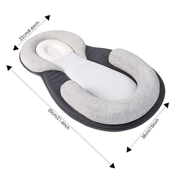 Newborn sleep positioner bed with gentle support, promoting healthy sleep and preventing flat head syndrome.