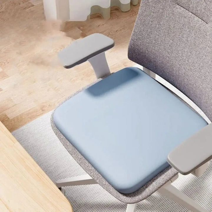 Non-slip car seat cushion in a vehicle, providing travel comfort, posture support & pain relief.