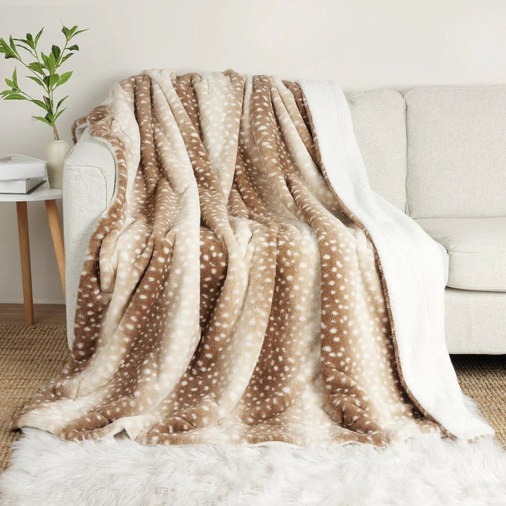 Unisex faux fur deer blanket, reversible plush throw for cozy bedroom accent and winter warmth.