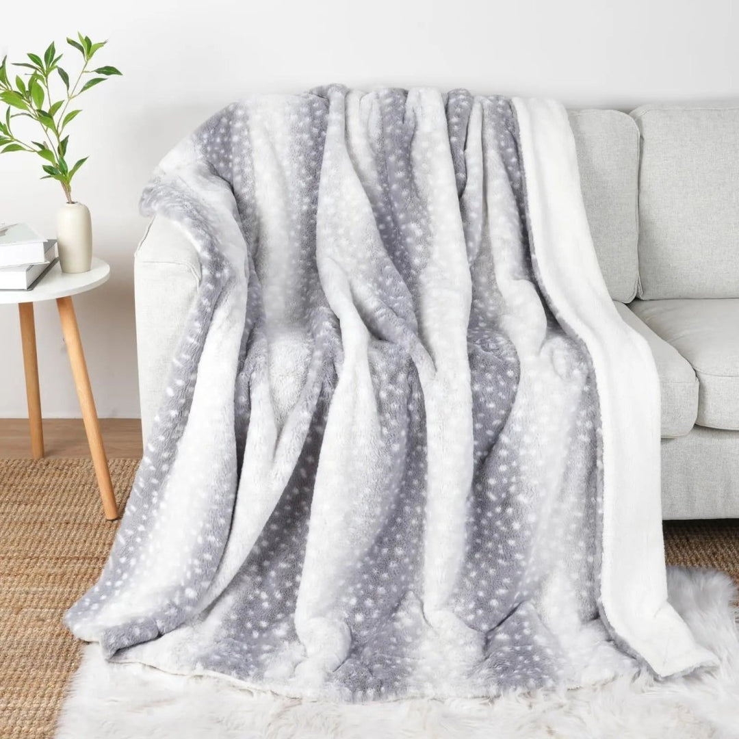 Detailed faux fur deer motif on a plush, reversible blanket. Soft and warm for ultimate cozy comfort.
