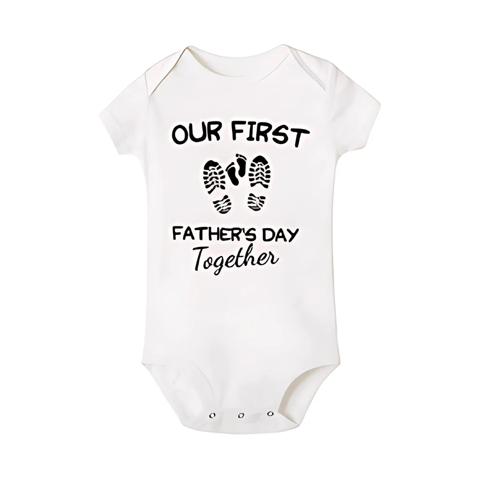 Smiling dad holding baby, both in 'First Father's Day' matching outfits, ideal fathers day gift