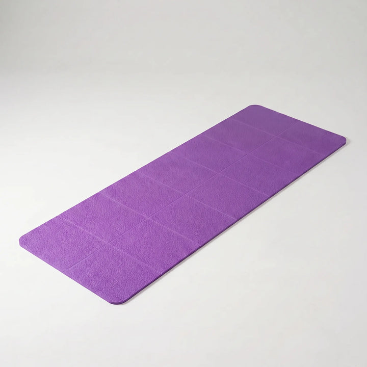 Compact, lightweight travel yoga mat, foldable design for easy packing. Non-slip surface for safe workouts.
