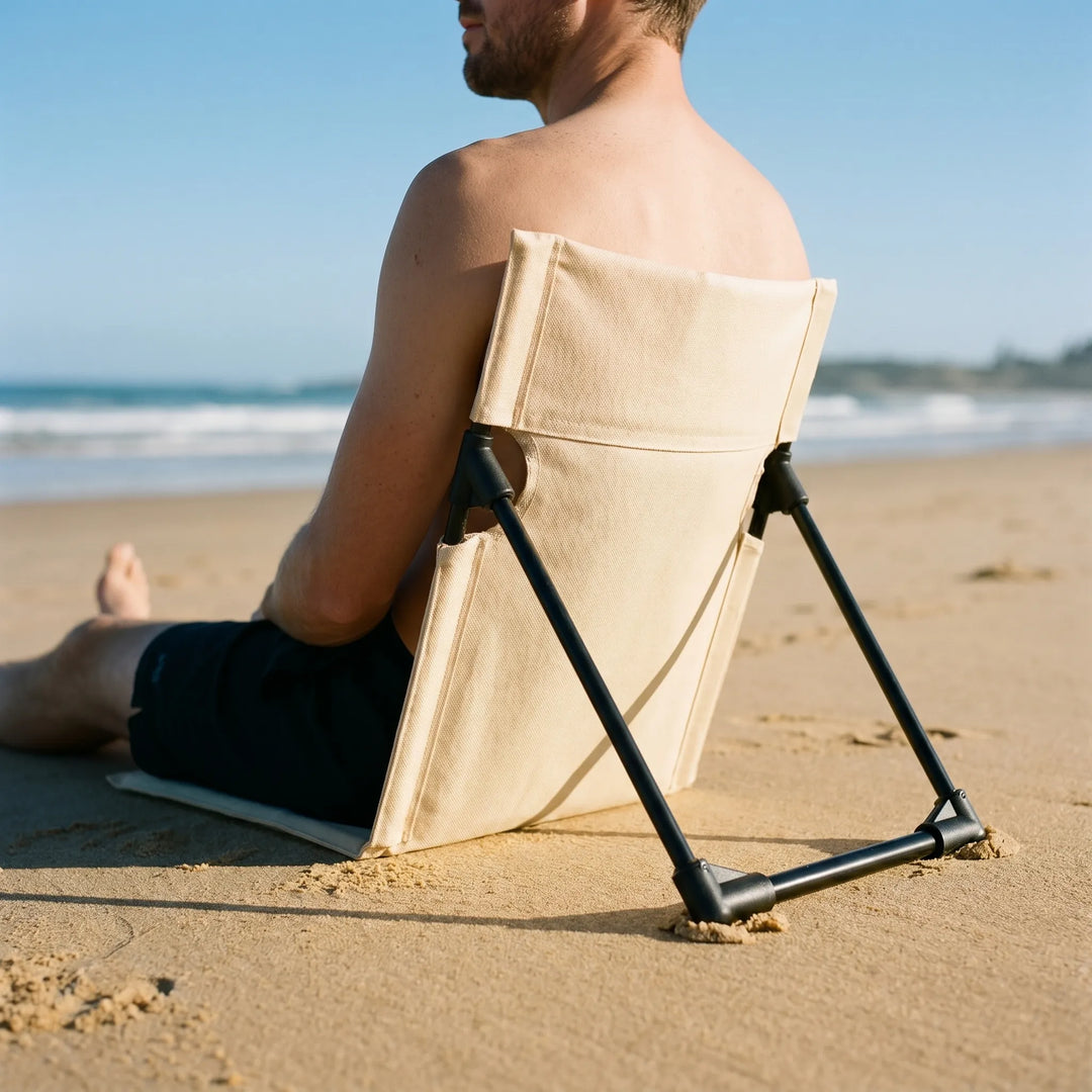 Unisex folding floor chair, lightweight & portable ground seat with adjustable back support for outdoor comfort.