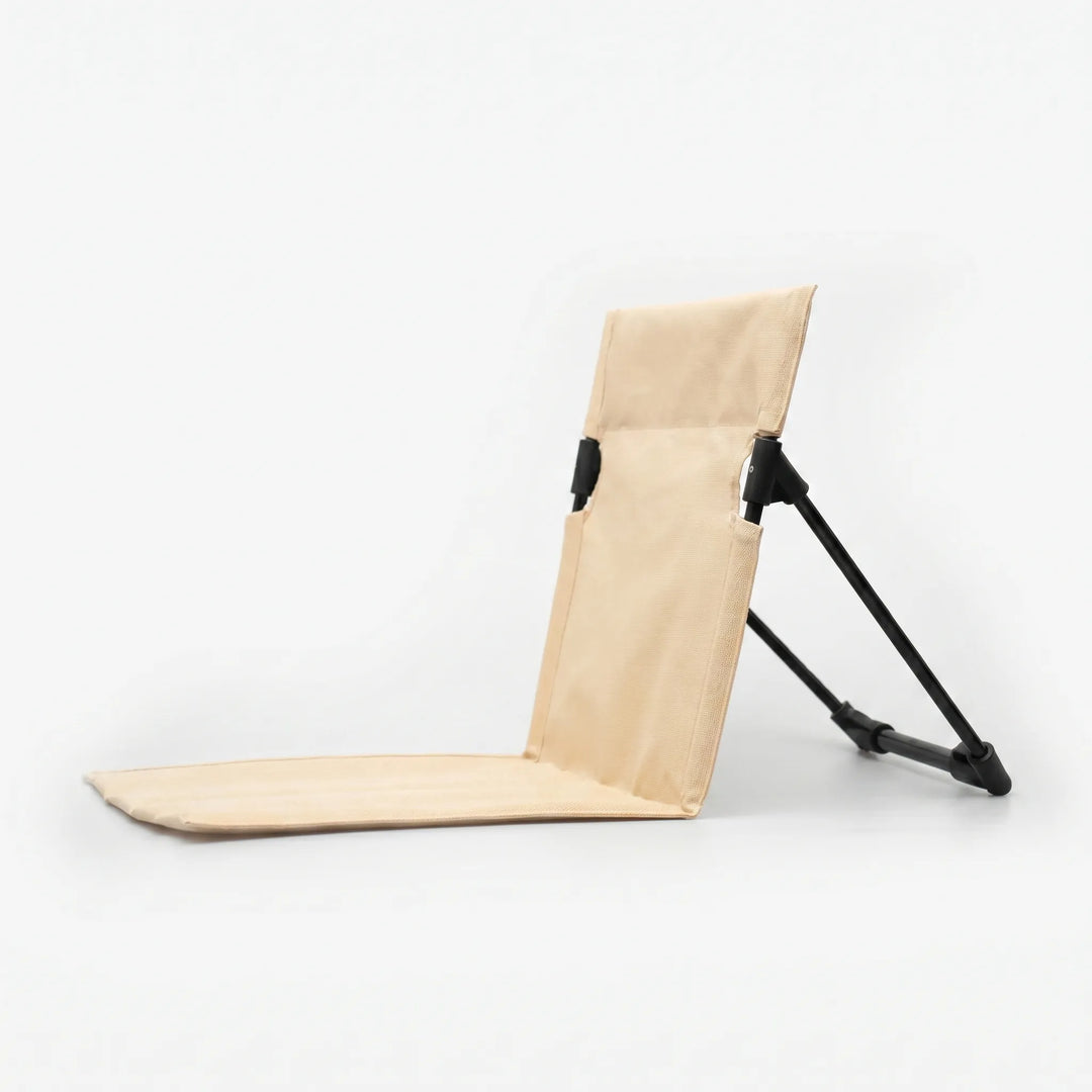 Quick setup unisex folding floor chair, offering convenient portable ground seating with comfortable back support outdoors.
