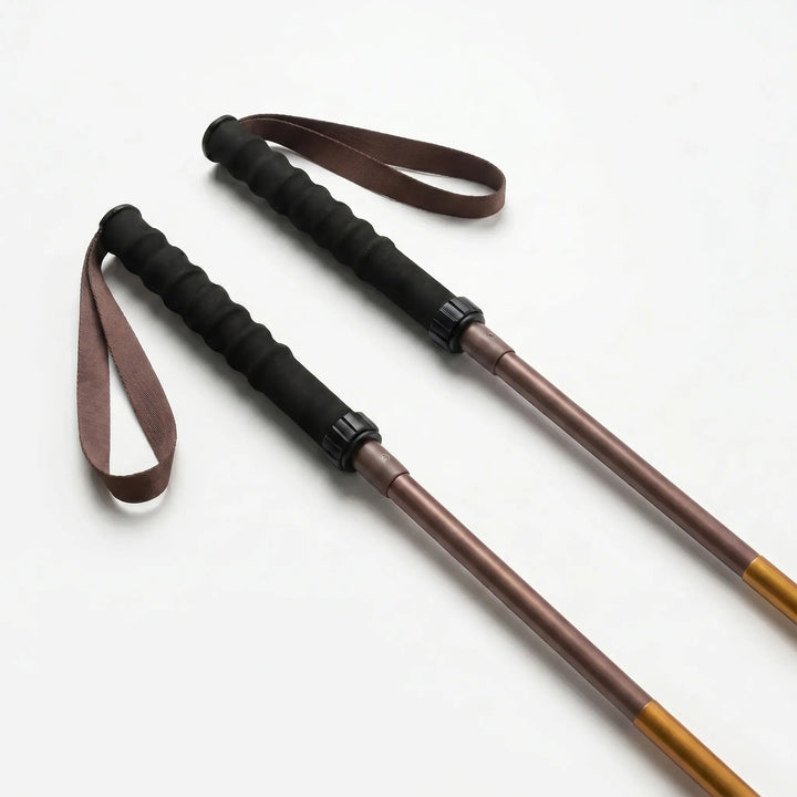Durable folding walking pole, unisex design. Quick-lock for secure, stable hiking on any trail.