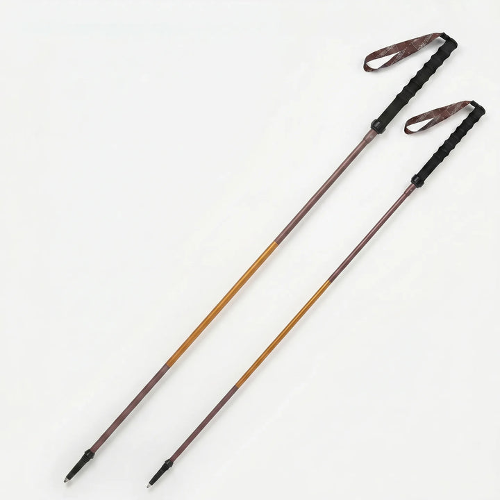 Adjustable folding walking pole provides support on trails. Lightweight, quick-lock for hikers.