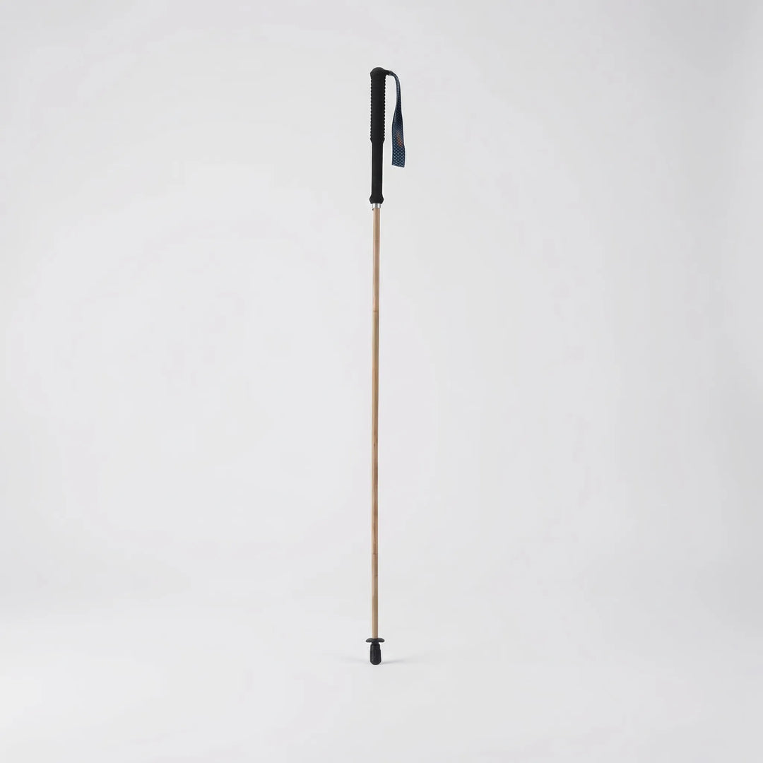 Compact folding trekking pole shown in its collapsed state, highlighting its portability for backpack storage.