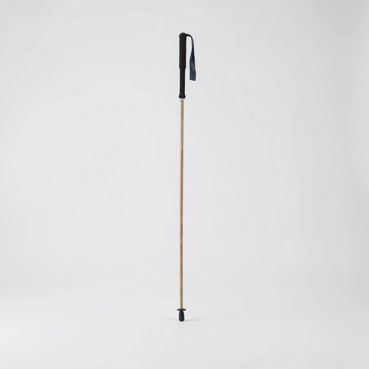 Compact folding trekking pole shown in its collapsed state, highlighting its portability for backpack storage.