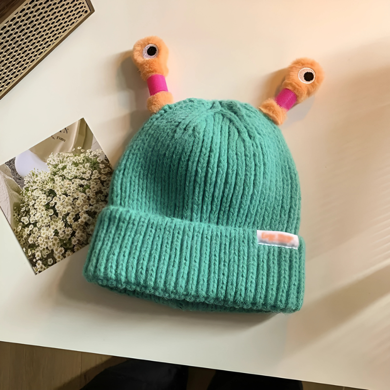 Child playing in the snow wearing a Fun Monster Glowing Knit Hat, warm and playful winter hat