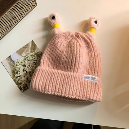 Glowing Monster Knit Hat in low light, highlighting its bright glow, unique winter accessory