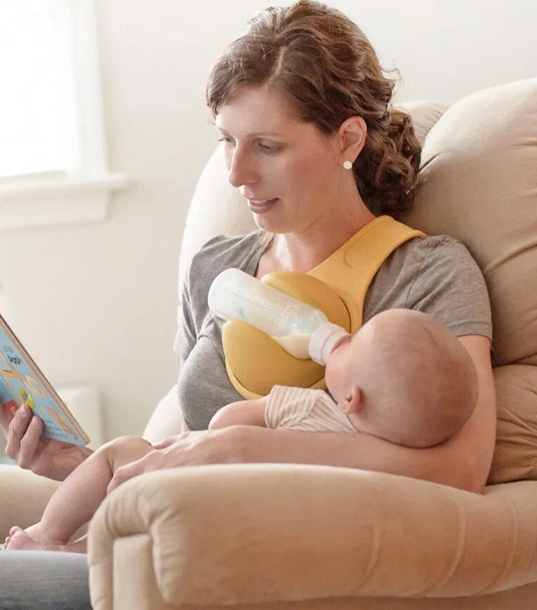 Parent demonstrating hands-free bottle holder, making infant care and baby feeding simpler for multitasking.
