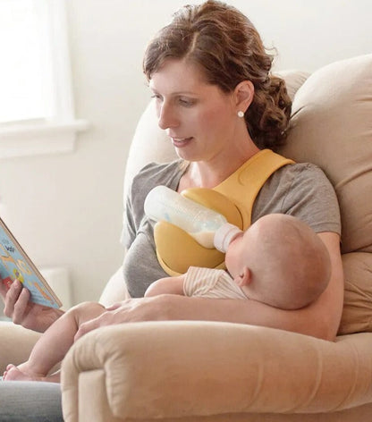 Parent demonstrating hands-free bottle holder, making infant care and baby feeding simpler for multitasking.